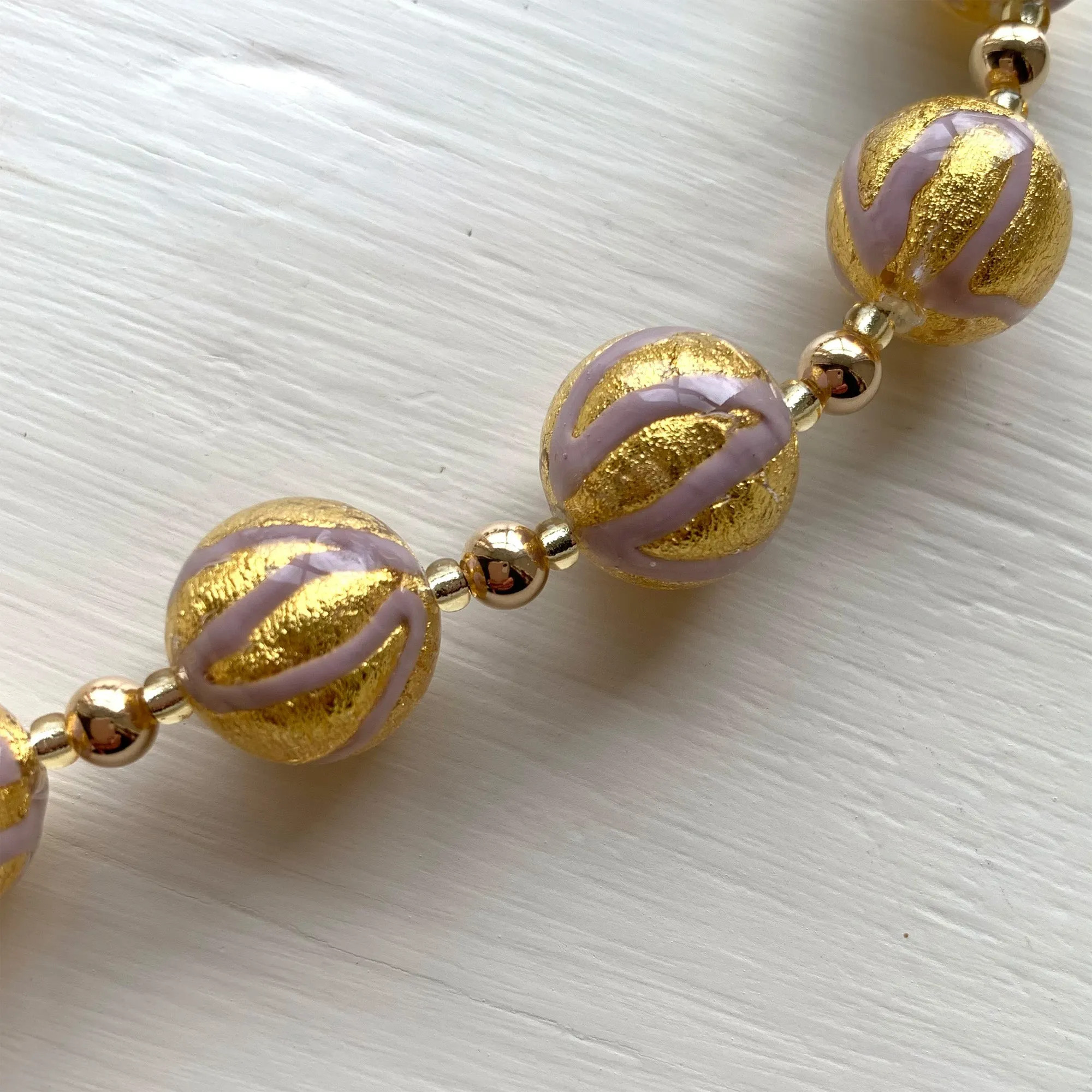 Necklace with purple pastel drizzle and gold Murano glass small sphere beads on gold